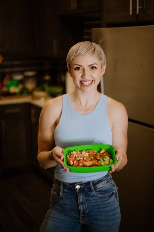 Anna Quinn holding a meal prep bowl of food