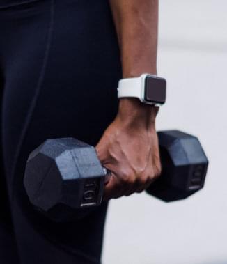 woman's hand holding kettle bell